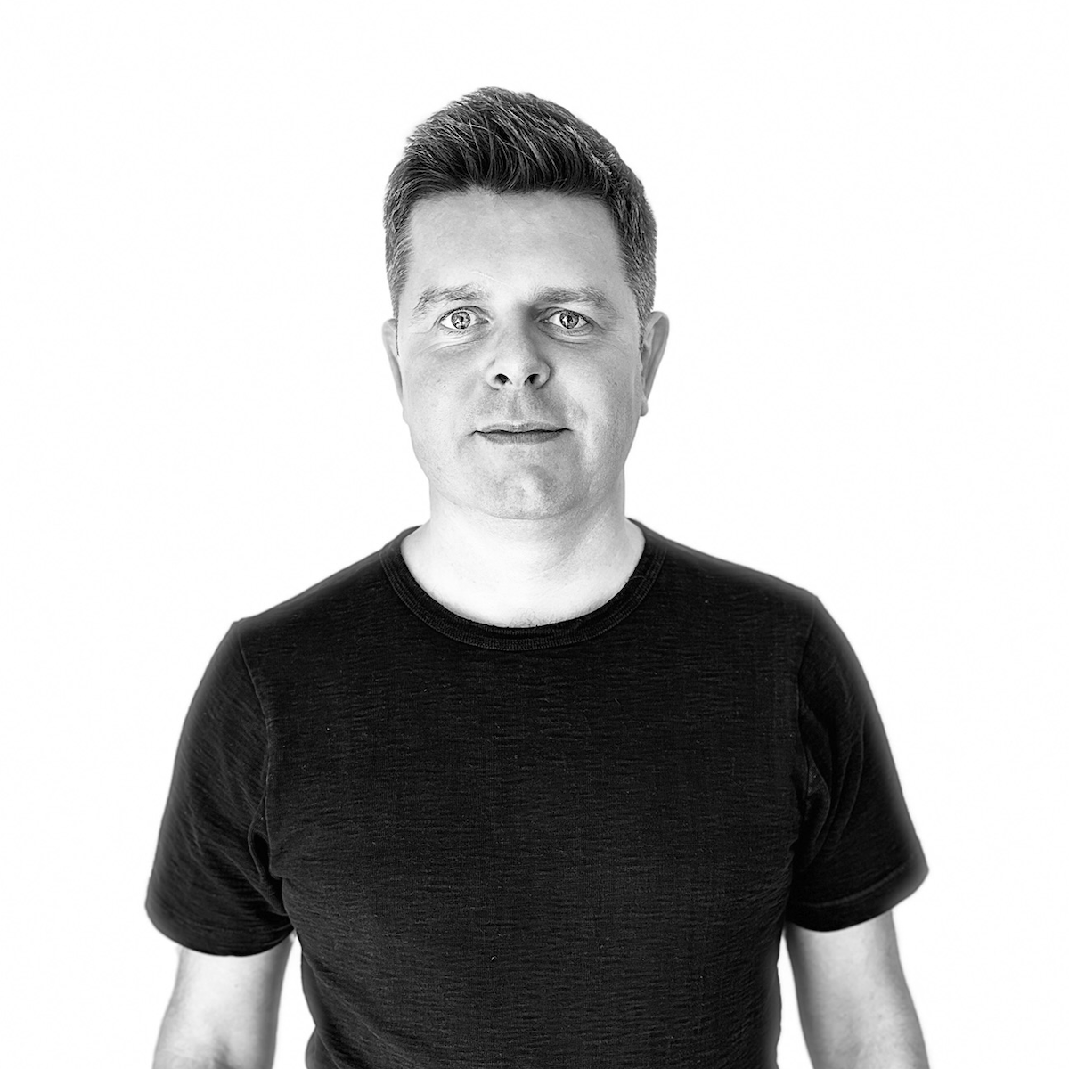A portrait of Jamie in a plain black t-shirt.